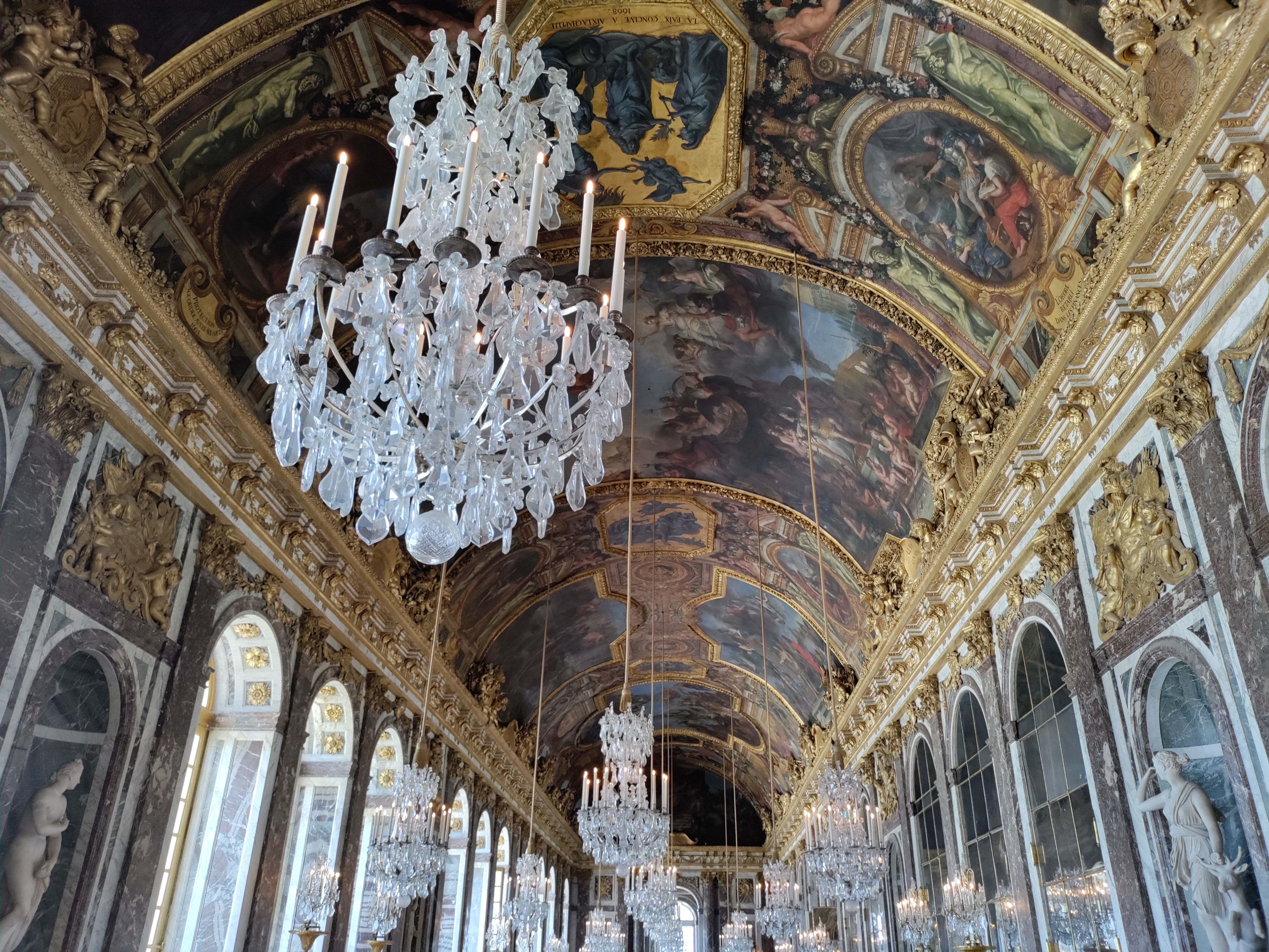 Painting on the ceiling in the Hall of Mirrors inside the Palais de Versailles.